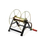 On voit un enrouleur de tuyau d'arrosage en métal au design chic et vintage.